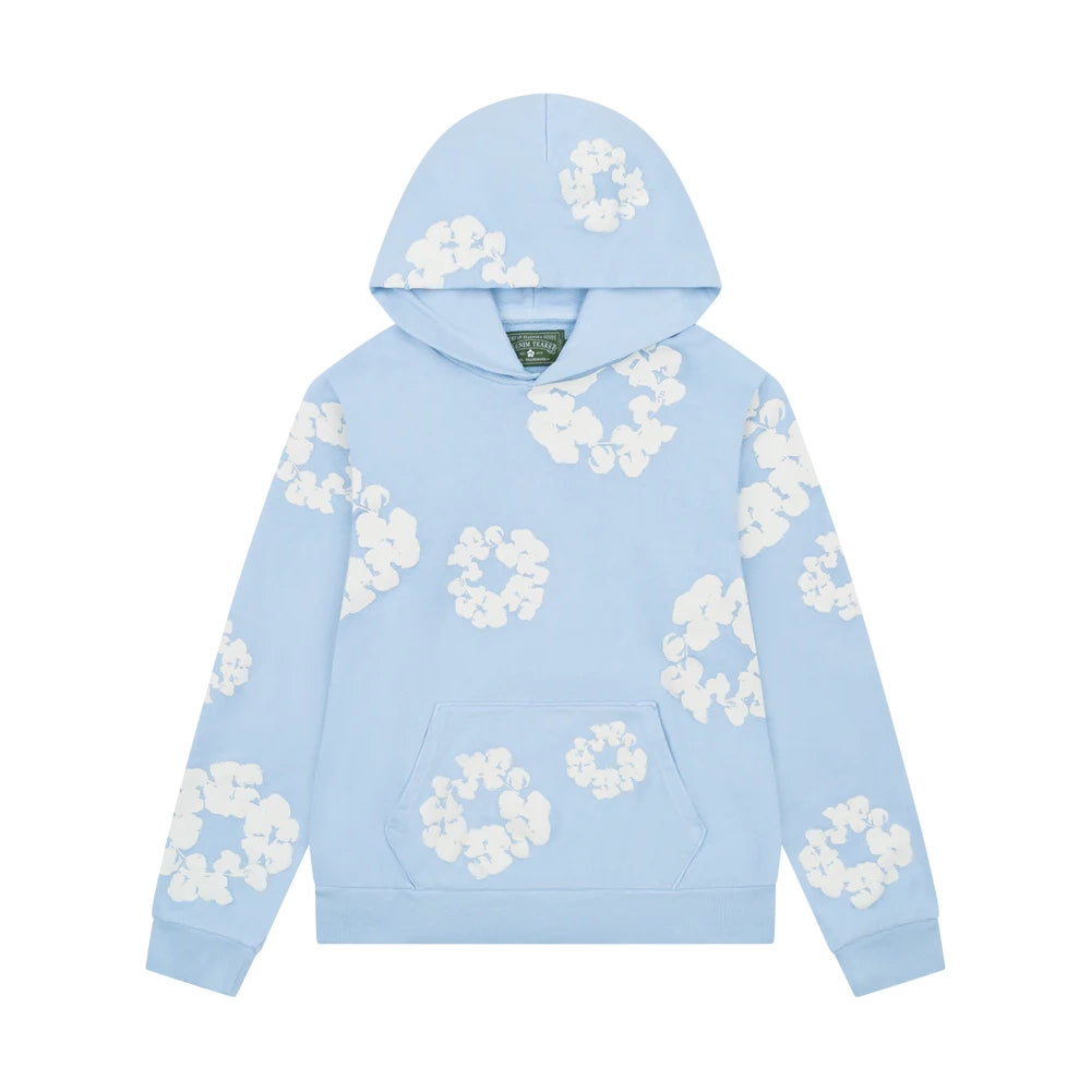 Denim Tears Cotton Wreath Sweatshirt in Powder Blue with puff-printed wreath design, soft cotton fabric, and relaxed fit for elevated streetwear style