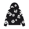 Denim Tears Cotton Wreath Sweatshirt in Black with puff-printed wreath design, soft cotton fabric, and relaxed fit for cultural and streetwear impact