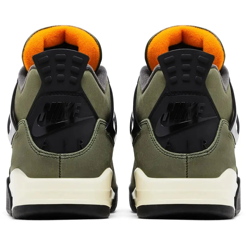 Undefeated x Air Jordan 4 (2025 reissue) in olive nubuck with black wings/eyelets, Nike Air heel tab, orange lining, Velcro tongue patches, off-white midsole, visible heel Air unit.