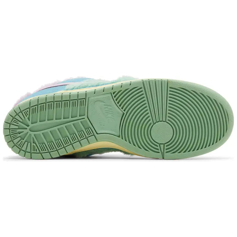 Verdy x Nike Dunk Low SB 'Visty' with green furry upper, pastel blue suede, pink Swoosh, yellow midsole, and Visty character branding on tongue and insole