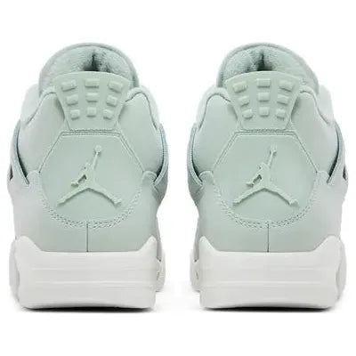 Women’s Air Jordan 4 Retro 'Seafoam' with pale green leather upper, silver eyelets, tonal Jumpman logos, breathable mesh panels, and off-white midsole with visible Air unit.